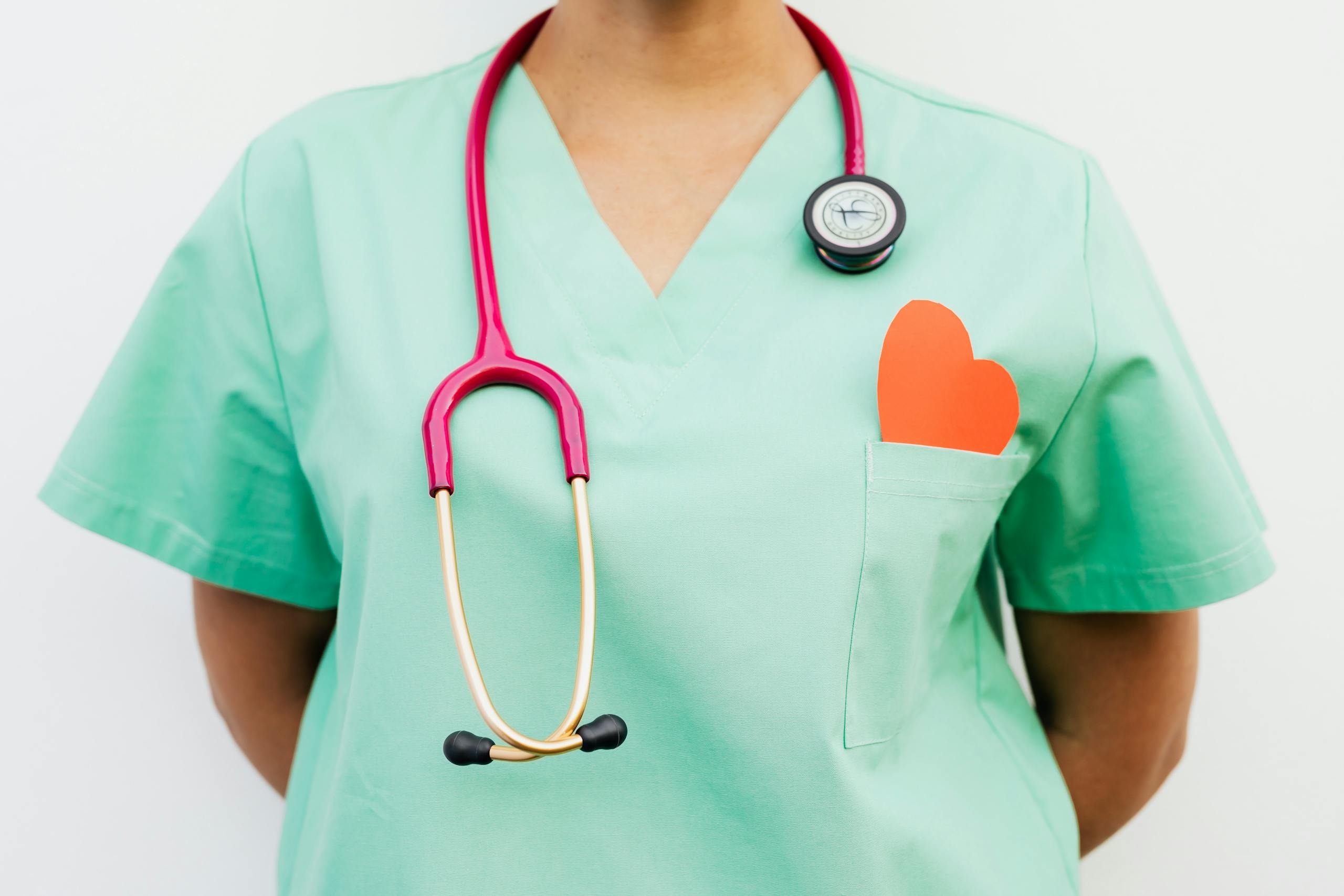 A Stethoscope Hanging on Medical Professional's Neck Wearing a Green Uniform